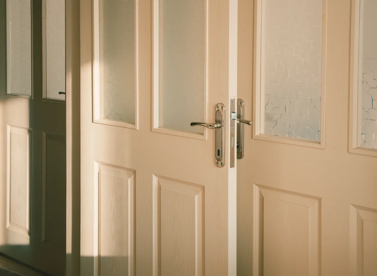 A white door with glazed panels and a door handle