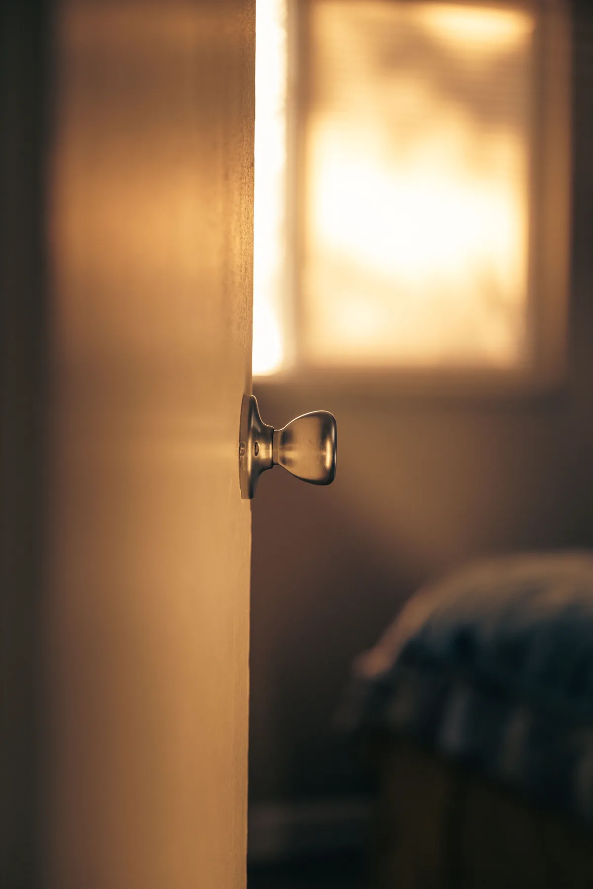 Close-up of a door knob on a door in soft light
