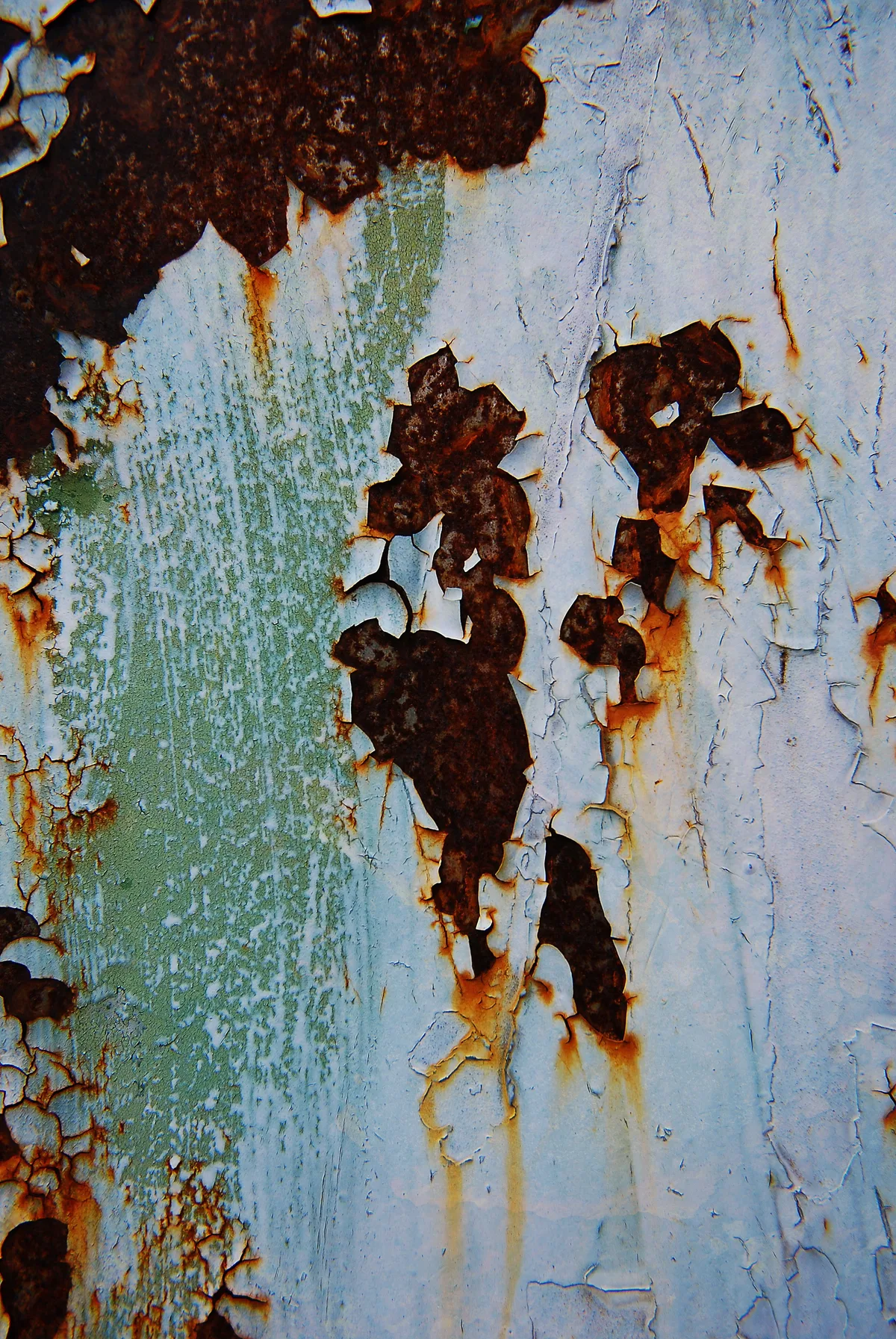 A metal surface with rust and flaking paint