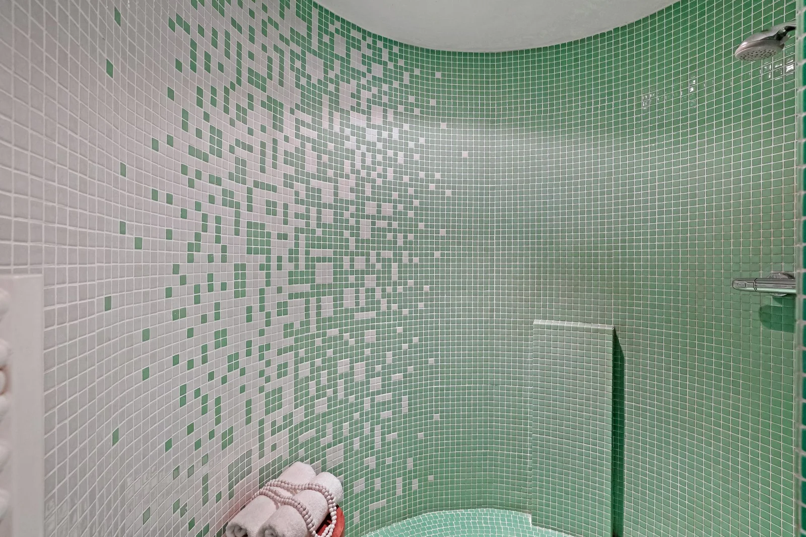 Bathroom with green glass mosaic tiles and light grout